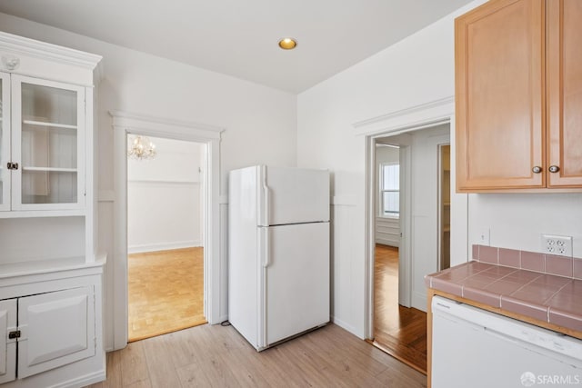 3046-3048 Polk St, San Francisco, CA 94109 - kitchen featuring white appliances, light wood-style flooring, tile counters, recessed lighting, and glass insert cabinets