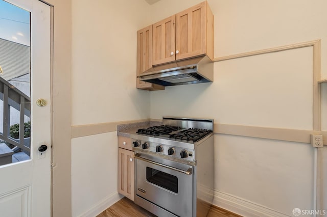 3046-3048 Polk St, San Francisco, CA 94109 - kitchen featuring luxury stove, under cabinet range hood, light brown cabinets, and light wood-style floors