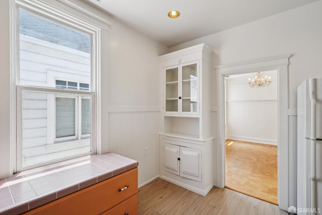 3046-3048 Polk St, San Francisco, CA 94109 - interior space with light wood finished floors and a chandelier
