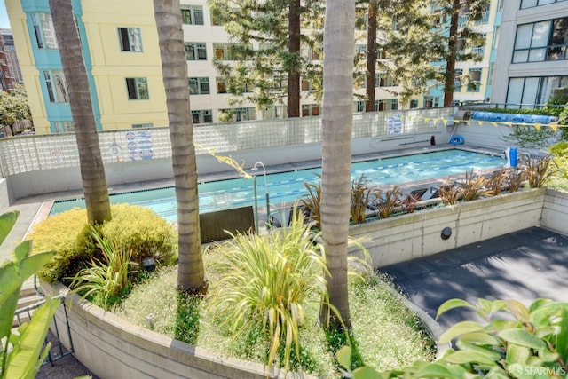 view of pool featuring fence