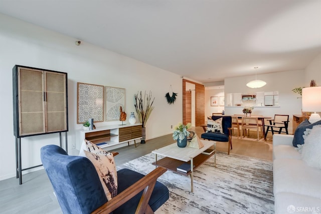 living area featuring baseboards and wood finished floors