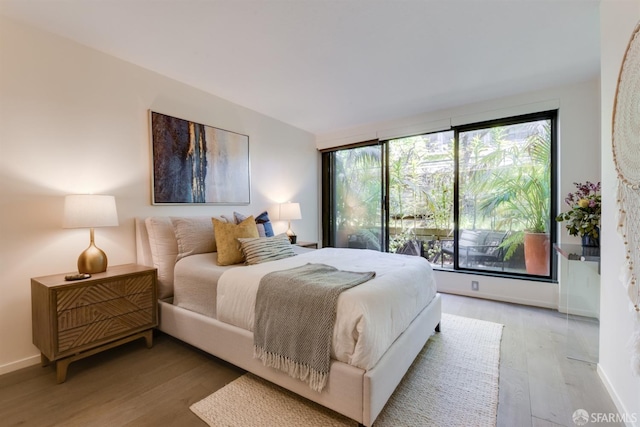 bedroom featuring light wood-style flooring and baseboards