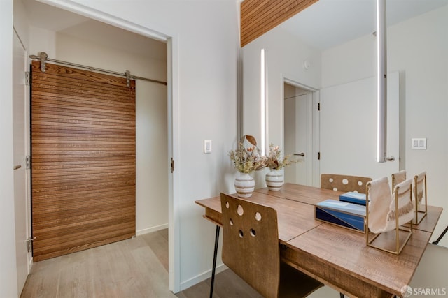 bathroom with baseboards and wood finished floors