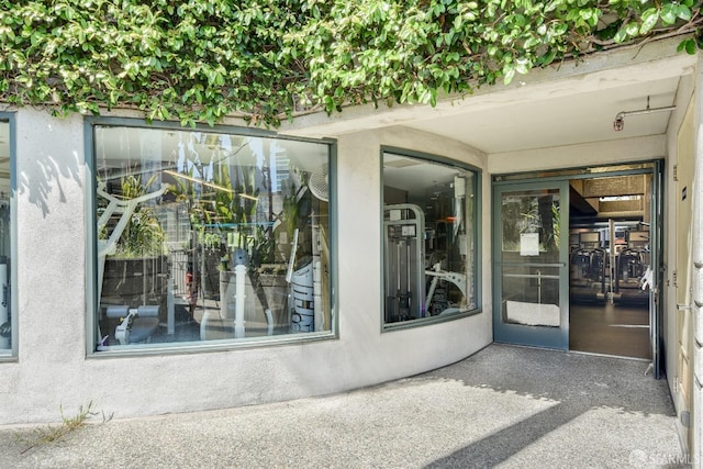 entrance to property with stucco siding