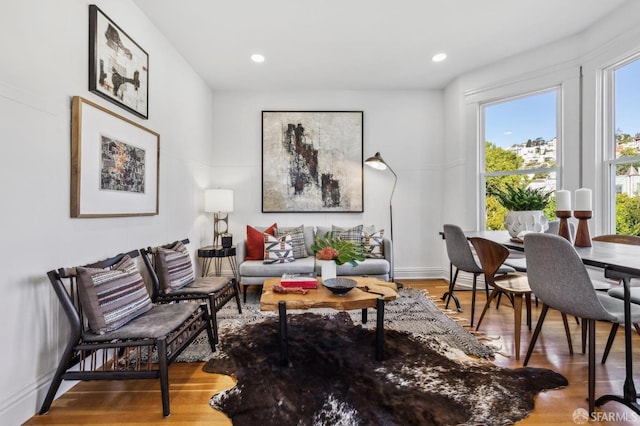 living room featuring baseboards, recessed lighting, and wood finished floors