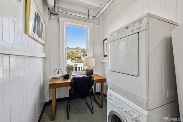 washroom with laundry area and stacked washer / drying machine