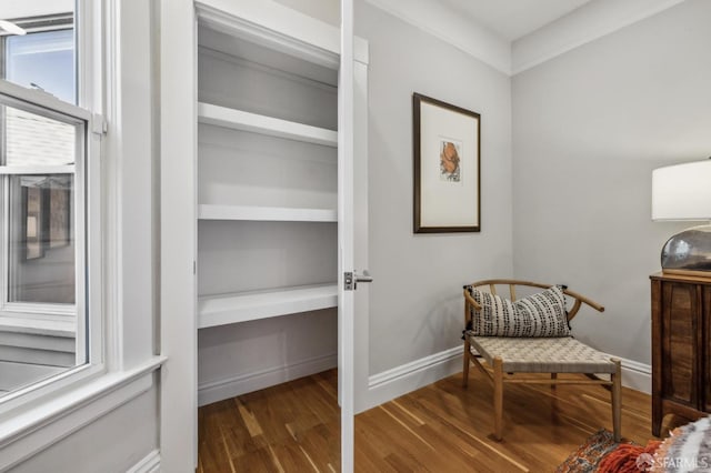 sitting room featuring baseboards and wood finished floors