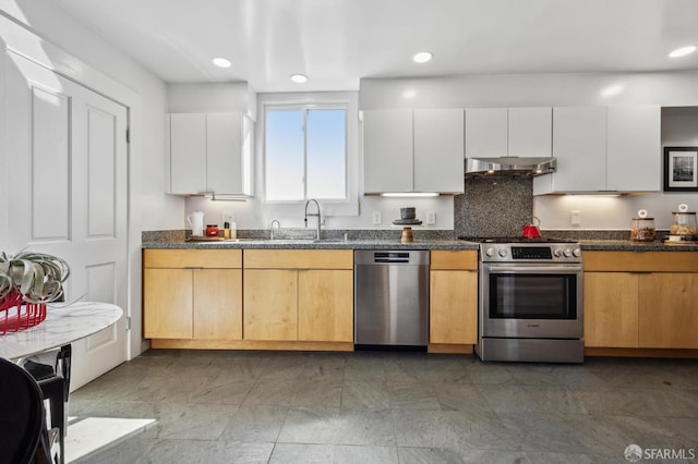 kitchen with white cabinetry, appliances with stainless steel finishes, recessed lighting, and under cabinet range hood