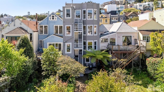 rear view of house featuring a residential view and stairs