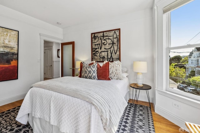 bedroom with wood finished floors and baseboards