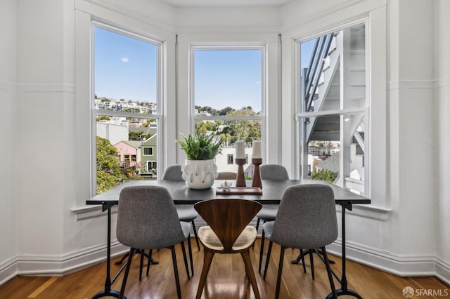 dining area featuring baseboards and wood finished floors
