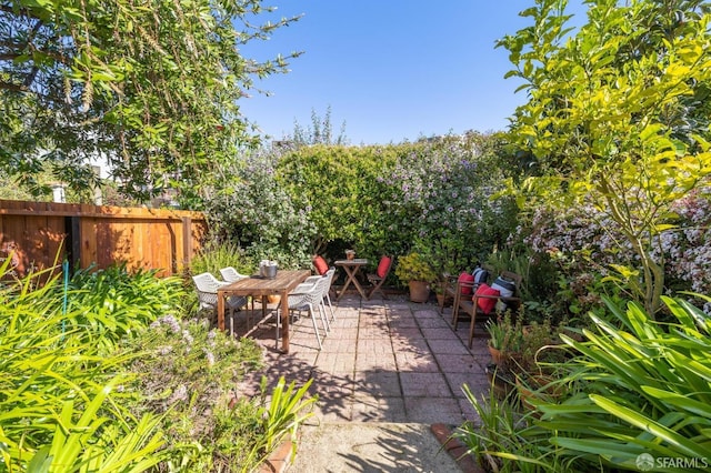view of patio with a fenced backyard and outdoor dining area