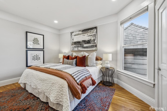 bedroom with baseboards, recessed lighting, and wood finished floors