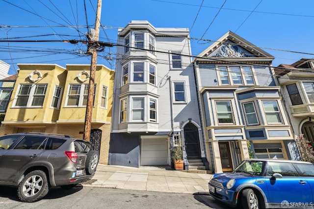townhome / multi-family property with an attached garage, stucco siding, and brick siding