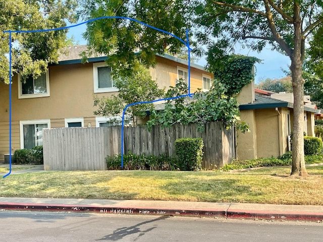 view of side of property with a lawn