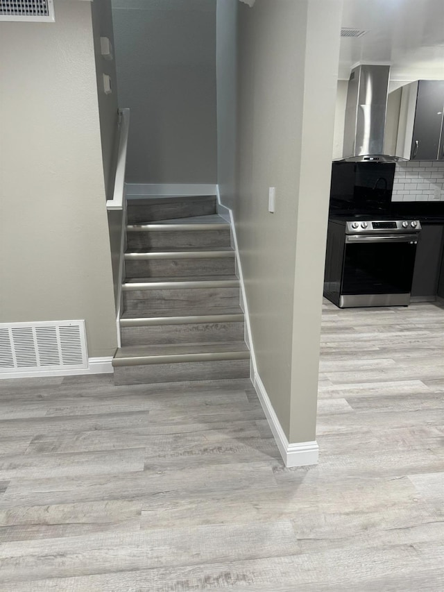 stairway with hardwood / wood-style flooring