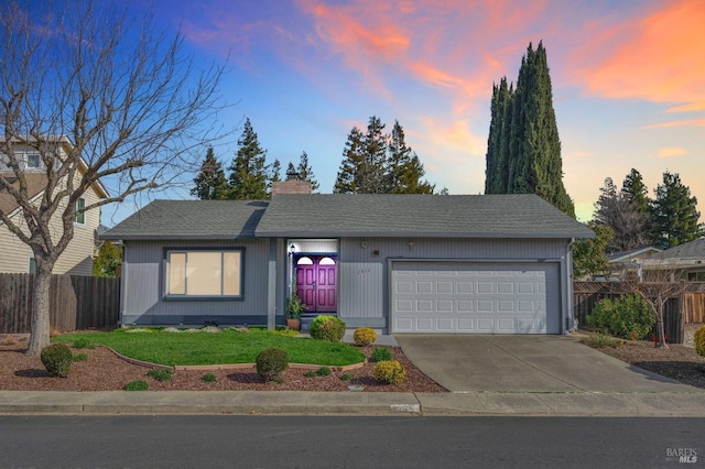 ranch-style home with a garage, a shingled roof, fence, concrete driveway, and a chimney