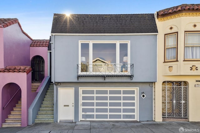 view of front of house with a garage and a balcony