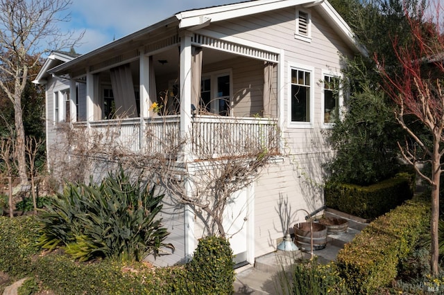 view of side of home featuring a balcony