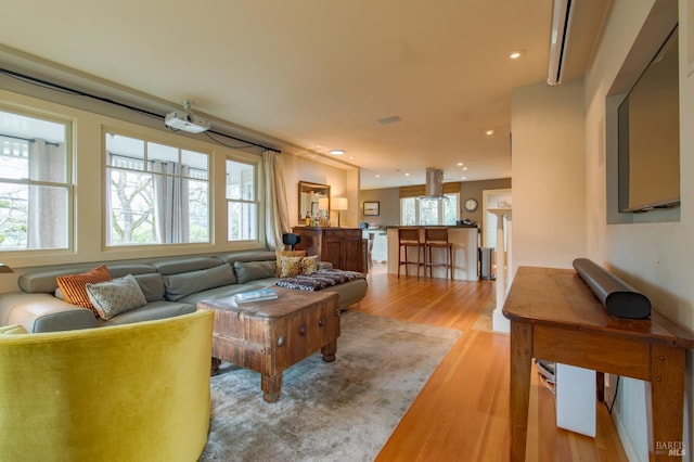 living area featuring recessed lighting, plenty of natural light, and light wood-style floors