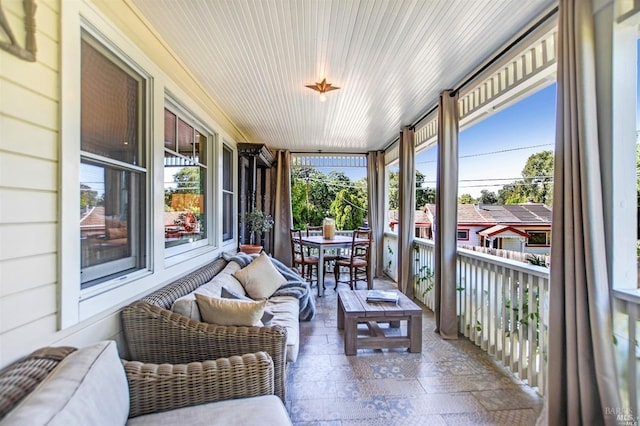 sunroom featuring wood ceiling