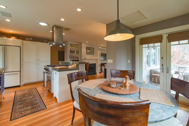 dining space with visible vents, recessed lighting, french doors, and light wood-style floors
