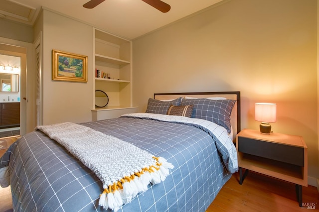 bedroom featuring a closet, wood finished floors, and a ceiling fan