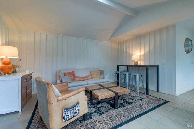 living room with tile patterned floors, vaulted ceiling with beams, and baseboards