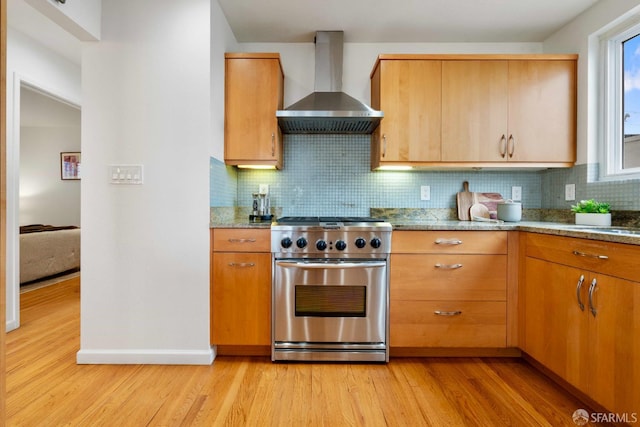 372 Baltimore Way, San Francisco, CA 94112 - kitchen featuring wall chimney exhaust hood, high end stainless steel range, light wood-type flooring, backsplash, and stone counters