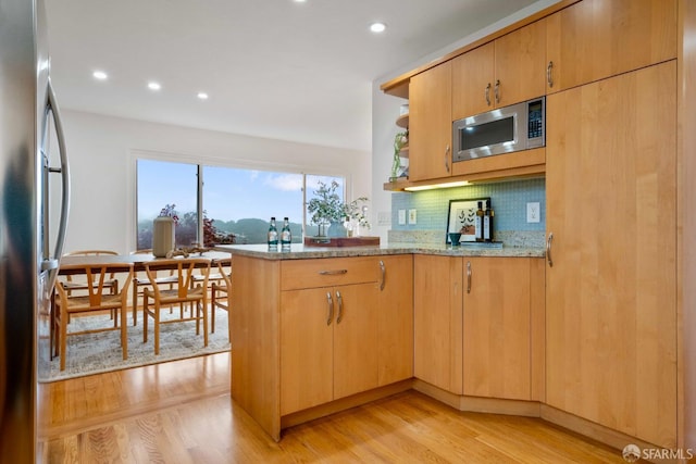 372 Baltimore Way, San Francisco, CA 94112 - kitchen featuring stainless steel appliances, light stone counters, decorative backsplash, recessed lighting, and light wood-style flooring