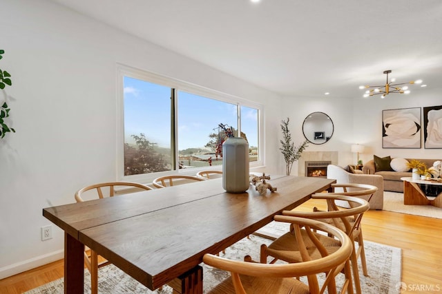 372 Baltimore Way, San Francisco, CA 94112 - dining room with a tile fireplace, a chandelier, and light wood-style floors