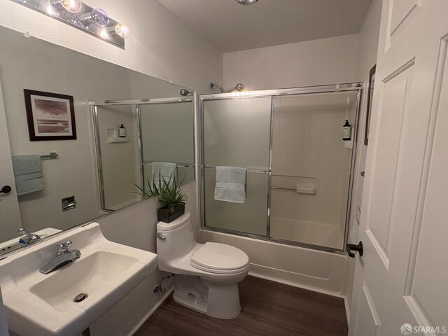 450 Carl St, San Francisco, CA 94117 - full bathroom featuring wood finished floors and bath / shower combo with glass door