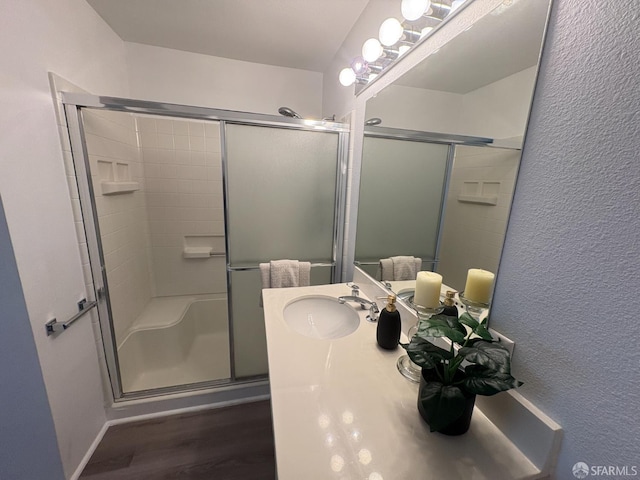 450 Carl St, San Francisco, CA 94117 - full bathroom featuring a shower stall, wood finished floors, vanity, and a textured wall