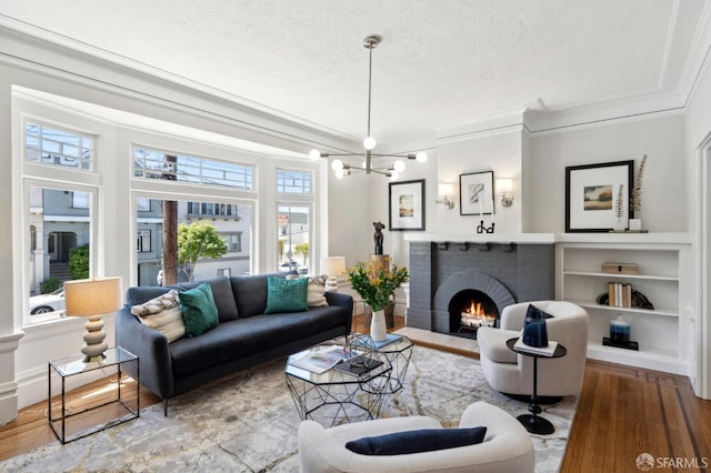 510 11th Ave, San Francisco, CA 94118 - living area featuring ornamental molding, wood finished floors, a textured ceiling, built in features, and a fireplace
