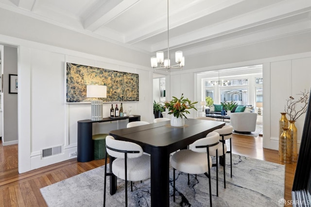 510 11th Ave, San Francisco, CA 94118 - dining room featuring a chandelier, beamed ceiling, a decorative wall, wood finished floors, and crown molding