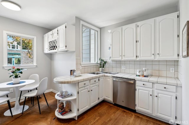 510 11th Ave, San Francisco, CA 94118 - kitchen with dishwasher, tile counters, a sink, and white cabinetry