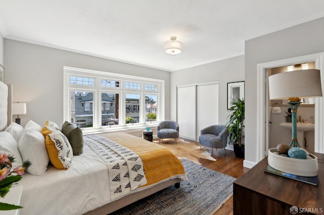 510 11th Ave, San Francisco, CA 94118 - bedroom featuring wood finished floors, crown molding, a closet, and baseboards
