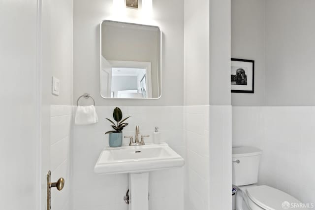 510 11th Ave, San Francisco, CA 94118 - bathroom featuring tile walls, toilet, and wainscoting