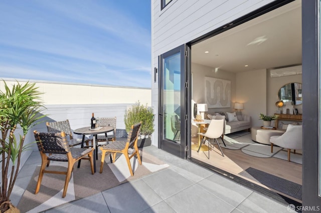 balcony with a water view and a patio area