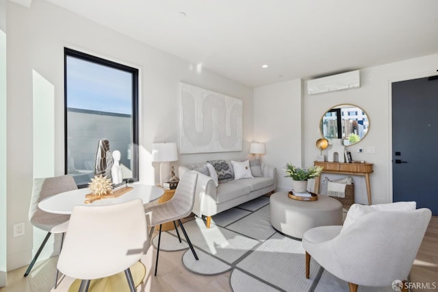 living room with light hardwood / wood-style flooring and a wall mounted AC