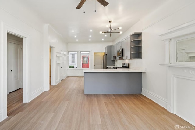 968-970 Broadway, San Francisco, CA 94133 - kitchen with stainless steel appliances, open shelves, a peninsula, light countertops, and ceiling fan