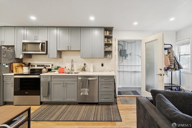 968-970 Broadway, San Francisco, CA 94133 - kitchen with stainless steel appliances, gray cabinetry, light wood-style flooring, light countertops, and recessed lighting