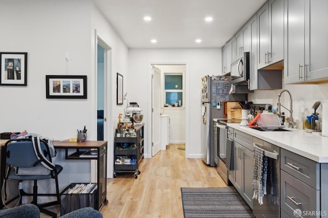 968-970 Broadway, San Francisco, CA 94133 - kitchen with stainless steel appliances, gray cabinetry, recessed lighting, light countertops, and light wood-style flooring