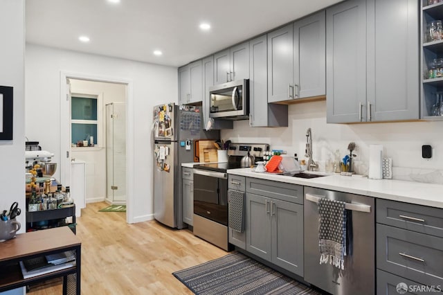 968-970 Broadway, San Francisco, CA 94133 - kitchen with appliances with stainless steel finishes, gray cabinets, light wood finished floors, open shelves, and recessed lighting
