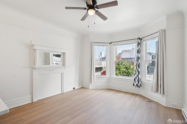 968-970 Broadway, San Francisco, CA 94133 - unfurnished room featuring wood finished floors, baseboard heating, healthy amount of natural light, and a ceiling fan