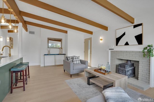 4330 Jana Vista Rd, El Sobrante, CA 94803 - living area featuring a wood stove, light wood finished floors, and baseboards