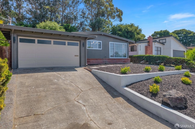 4330 Jana Vista Rd, El Sobrante, CA 94803 - view of front facade featuring driveway, a garage, brick siding, and stucco siding