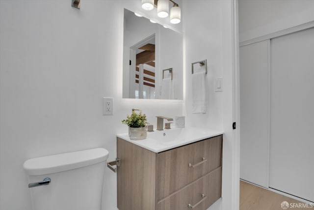 4330 Jana Vista Rd, El Sobrante, CA 94803 - half bathroom featuring toilet, vanity, and wood finished floors