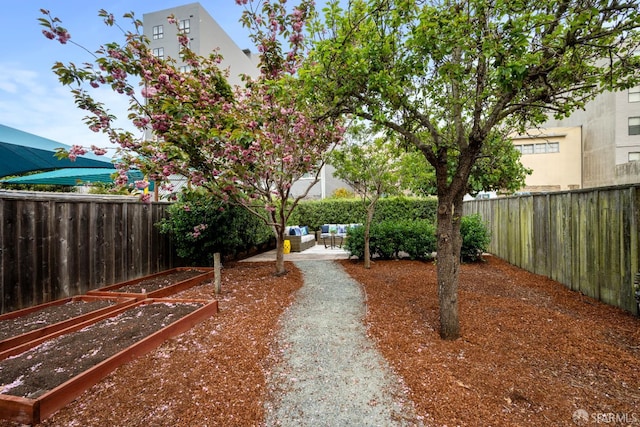 1871 Alemany Blvd, San Francisco, CA 94112 - fenced backyard featuring a vegetable garden, a patio, and an outdoor living space