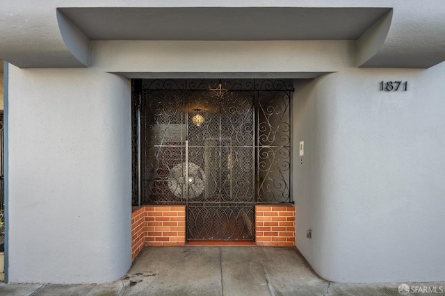 1871 Alemany Blvd, San Francisco, CA 94112 - property entrance featuring stucco siding, a gate, and brick siding